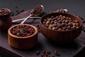 Spice allspice brown color not ground in a wooden saucer. Asian food photo