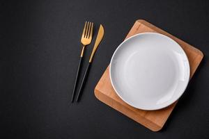 Empty ceramic round plate on dark textured concrete background photo