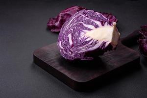 Fresh beautiful red cabbage with textured leaves on a dark concrete background photo