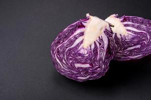 Fresh beautiful red cabbage with textured leaves on a dark concrete background photo