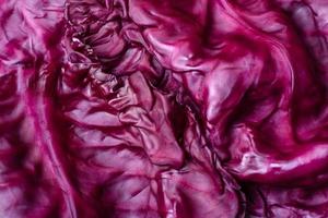Fresh beautiful red cabbage with textured leaves on a dark concrete background photo