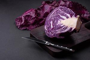 Fresh beautiful red cabbage with textured leaves on a dark concrete background photo