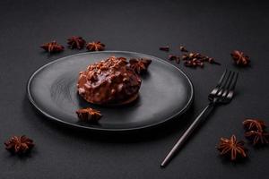 deliciosa tarta de chocolate con nueces en un plato de cerámica negra foto