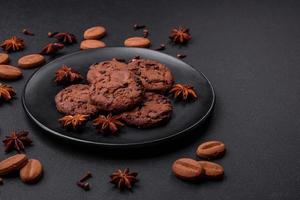 deliciosas galletas de chocolate con nueces en un plato de cerámica negra foto