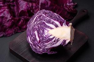 Fresh beautiful red cabbage with textured leaves on a dark concrete background photo