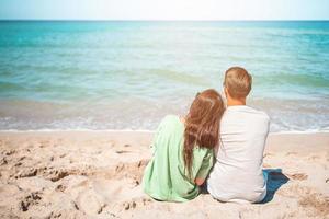 Young couple on white beach during summer vacation. photo