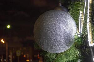 Christmas Bauble Coloured and Shiny on a Pine Tree in Winter Celebrations photo