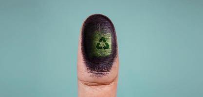 Recycle Symbol as Fingerprint on Thumb. World Earth Day, Recycling and ESG Concept. Green Energy, Renewable and Sustainable Resources. Environmental Care. photo