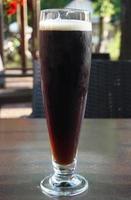 Glass of Dark Beer on a Table photo