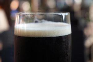 Glass of Dark Beer, Defocused Background photo