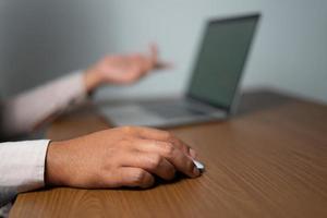 Man appoints a report on a laptop for business concepts photo