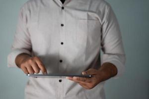 The man holding the tablet is analyzing business and market reports photo