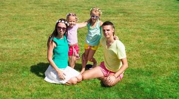 Happy family with two children outdoors on summer day photo