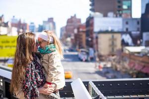 Adorable little girl and mother enjoy sunny day on New York's High Line photo