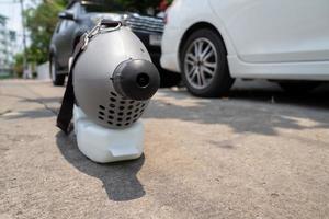 sterilizing machine water spray is standing in front of personal vehicles and ready to use for kill and protect the coronavirus photo