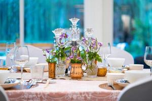 the luxury dinner set on the table with green and pink theme. photo