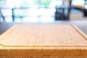 wooden cutting board base on the table with perspective wood over blur light bokeh background for package and product content mockup banner and advertisment template. photo