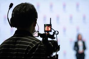 Asian man Videographer in backside are shooing and recording video in Speech event on the stage. photo