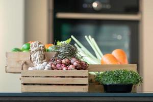 Group of vegetable Carrot, Potato, Lime, Tomato, Onion, Shallot bundle, Garlic bundle and Micro Herb in wood box. It's shot in studio light. photo