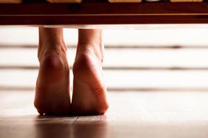 Closeup shot of dangling female bare feet photo