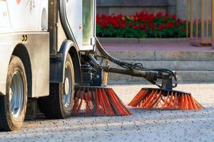 Sweeper cleaning machine on a city street photo