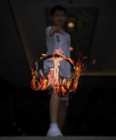 Headphone is floating and burning on the air in front of the boy, Conceptual image of hot and energy music, listen with the headphone photo