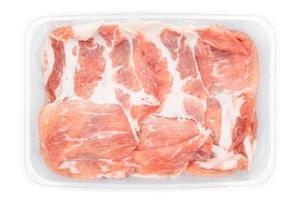 fresh Sliced raw pork ids isolated in plastic box on white clear background. Clipping Paths. photo