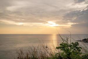 Twilight Golden time in the sea view of Phrom Thep Cape, the tropical sea sunset period, scenic point of Phuket Island, The Pearl of the Andaman Sea,Thailand popular for tourist in the world. photo