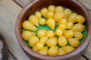 Thong Yod Dessert from Thailand, Egg yolk, sugar, and flower water are boiled in sugar syrup and formed into round balls to create this sugar lover sweet. photo