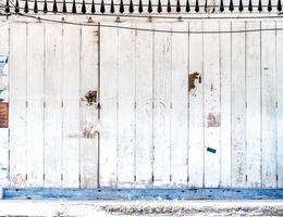 Old white and blue wood wall on foot path of Asia vintage building for background. photo