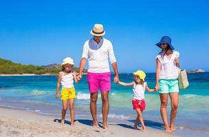 Happy family of four during beach vacation photo