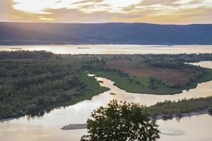 sunset on the Volga river. Natural landscape. reflection, blue sky and yellow sunlight. landscape during sunset. photo