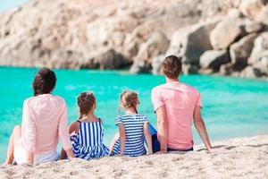 Young beautiful family on the beach photo