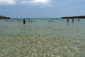NOTO, ITALY - JULY 18 2020 - Calamosche beach full of people with no social distancing after coronavirus quarentine photo