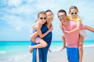 Happy family on the beach during summer vacation photo