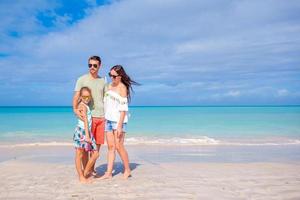 Happy family on the beach during summer vacation photo