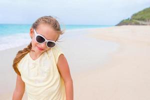 Cute little girl at beach during summer vacation photo