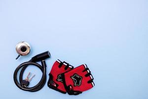 bicycle bell, gloves padlock on a blue background with copy space photo