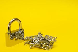 padlock with chain on yellow background with copy space photo