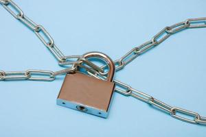 padlock on a chain on a blue background photo