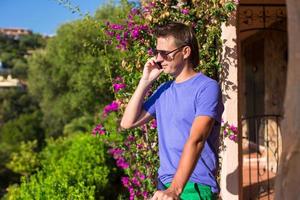 Young man talking on the phone at the balcony photo