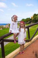 Adorable little girls outdoors during summer vacation photo