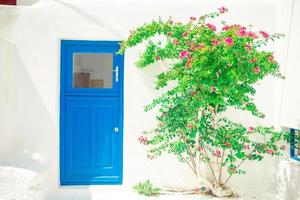 Traditional houses withe blue doors in the narrow streets of Mykonos, Greece. photo