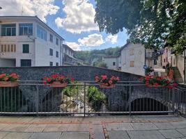 ancient roman bridge in grondona old medieval piedmont village photo