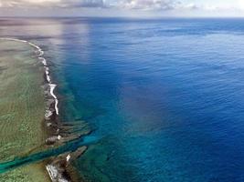 Pacific ocean reef waves Polynesia Cook Island tropical paradise aerial view photo