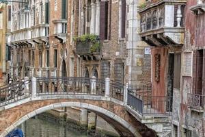 Venice bridge and channel reflections photo