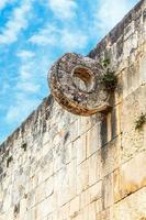 Mayan football game ring on the stone wall, Chichen Itza archaeological site, Yucatan, Mexico photo