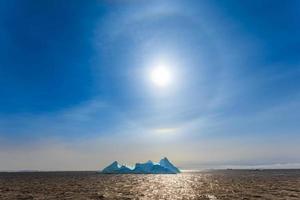Sun Halo shining over the blue iceberg and ocean, North Greenland photo