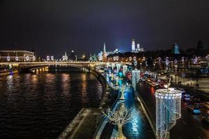 Night view to Moscow Kremlin and river banks decorated with NY ilumination with road full of traffic in the foreground, Moscow, Russia photo