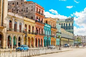 Old Spanish colonial living colorful houses across the road in the center of Havana, Cuba photo